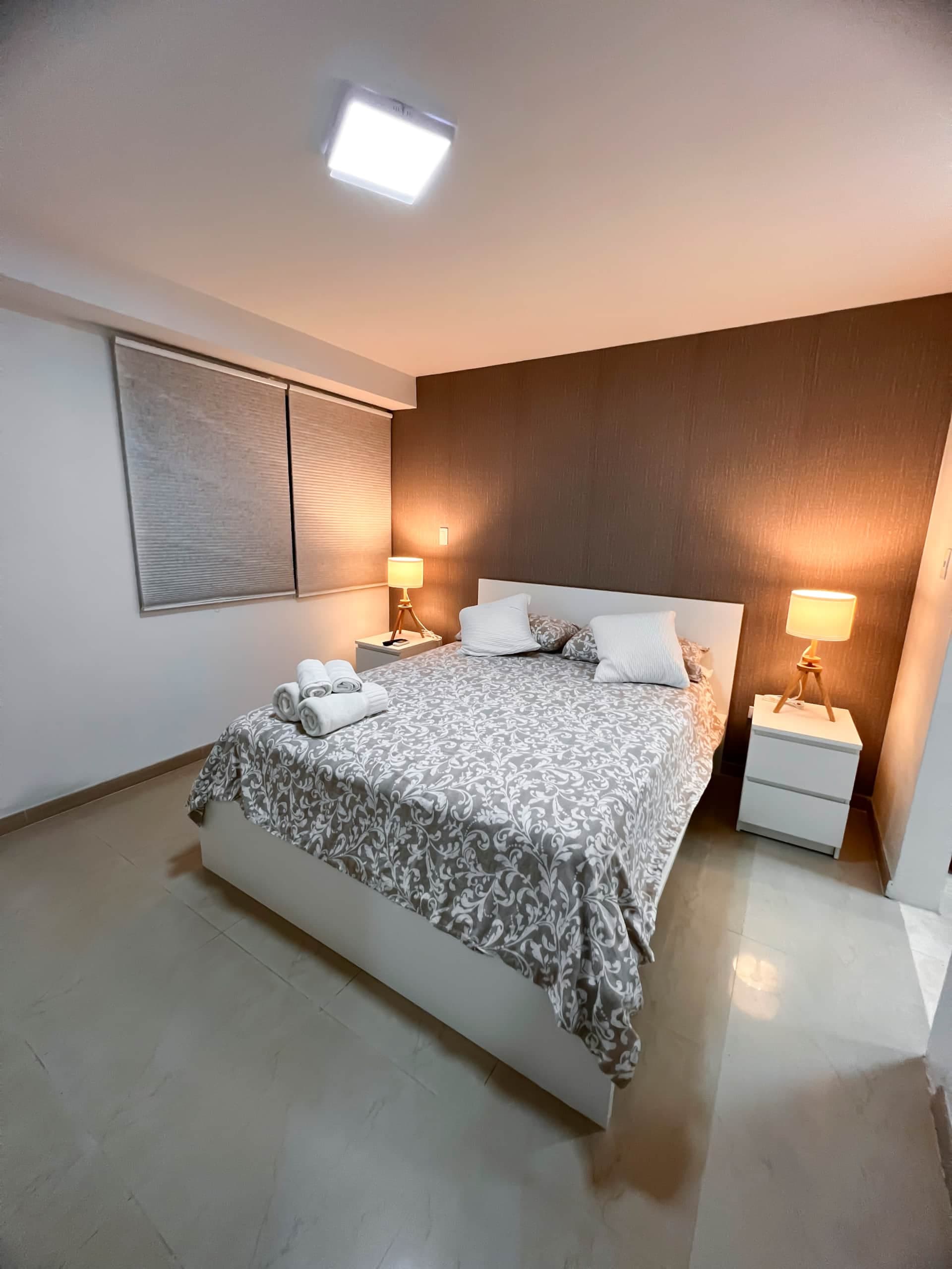 Dormitorio de Suite El Hatillo: apartamento compacto para dos